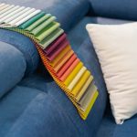 catalog_of_multi_colored_fabric_samples_on_sofa